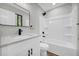 Bathroom featuring a modern vanity, a sleek mirror, and a shower-tub combo with white tile at 1829 Herringbone Holw, Lithonia, GA 30058