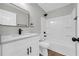 Bathroom boasts a modern vanity, stylish mirror, and a pristine white shower-tub combination at 1829 Herringbone Holw, Lithonia, GA 30058