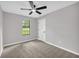 Neutral bedroom featuring a ceiling fan, carpeting, and a view to the outdoors at 1829 Herringbone Holw, Lithonia, GA 30058