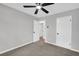 Bedroom features neutral walls, gray carpet, a ceiling fan, and doors leading to other rooms in the house at 1829 Herringbone Holw, Lithonia, GA 30058