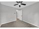 Bedroom features a ceiling fan, neutral walls, carpeting, and a door to the hallway at 1829 Herringbone Holw, Lithonia, GA 30058