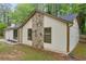 Side exterior view of home featuring stone accents, siding, dark roof, and lush greenery at 1829 Herringbone Holw, Lithonia, GA 30058