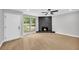Bright living room with wood floors, white trim, and a stunning rock fireplace feature at 1829 Herringbone Holw, Lithonia, GA 30058