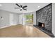 Living room features a stunning rock fireplace, wood floors, and abundant natural light at 1829 Herringbone Holw, Lithonia, GA 30058