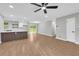 Bright living room with wood floors and white kitchen with breakfast bar in an open floorplan at 1829 Herringbone Holw, Lithonia, GA 30058
