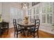 Cozy dining room featuring plantation shutters, hardwood floors, and a classic round table at 3025 Woodwalk Se Dr # 17, Atlanta, GA 30339