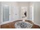 Hallway leading to bedroom and laundry room, with hardwood floors and a decorative rug at 3025 Woodwalk Se Dr # 17, Atlanta, GA 30339