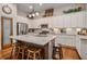 Charming kitchen boasts white cabinets, stainless steel appliances, and a large central island with seating at 3025 Woodwalk Se Dr # 17, Atlanta, GA 30339