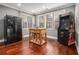 Eat-in kitchen with wood floors, black refrigerator, a table, and an arcade game at 3025 Woodwalk Se Dr # 17, Atlanta, GA 30339