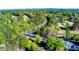 Scenic aerial of golf course, bridge, and clubhouse nestled in vibrant green trees and landscaping at 5010 Winding Hills Ln, Woodstock, GA 30189