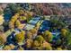 Community aerial featuring tennis courts, swimming pool and neighborhood clubhouse amidst fall foliage at 5010 Winding Hills Ln, Woodstock, GA 30189