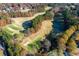 Scenic aerial view of the golf course winding through the community, surrounded by colorful trees at 5010 Winding Hills Ln, Woodstock, GA 30189