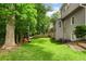 A spacious backyard with mature trees and green grass has room to spread out and relax at 5010 Winding Hills Ln, Woodstock, GA 30189