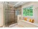 Beautifully designed bathroom with tiled glass enclosed shower and a window seat at 5010 Winding Hills Ln, Woodstock, GA 30189