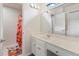 Bright bathroom featuring a vanity, a large mirror, and a colorful rug at 5010 Winding Hills Ln, Woodstock, GA 30189