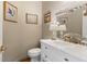 Charming powder room featuring a white vanity, decorative mirror, and elegant wall art at 5010 Winding Hills Ln, Woodstock, GA 30189