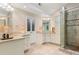 Bright bathroom featuring double sinks, granite countertops, and a glass enclosed shower at 5010 Winding Hills Ln, Woodstock, GA 30189