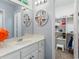 Bright bathroom with a vanity, large mirror, and walk-in closet at 5010 Winding Hills Ln, Woodstock, GA 30189