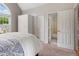 Bedroom showcasing closet and bathroom doors, providing a private ensuite experience at 5010 Winding Hills Ln, Woodstock, GA 30189