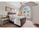 Comfortable bedroom with a decorative arched window and ceiling fan, providing natural light at 5010 Winding Hills Ln, Woodstock, GA 30189