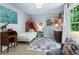 Bright bedroom with a beautiful rug, canopy bed, and neutral walls at 5010 Winding Hills Ln, Woodstock, GA 30189