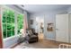 Light bedroom with a large window, gray chair, and view of closet at 5010 Winding Hills Ln, Woodstock, GA 30189