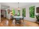 Charming dining room with hardwood floors, many windows, and decorative lighting at 5010 Winding Hills Ln, Woodstock, GA 30189