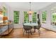 Bright and sunny dining room with hardwood floors, large windows, and modern chandelier at 5010 Winding Hills Ln, Woodstock, GA 30189