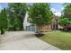Long driveway leading to the home's three-car garage and showing the house's side elevation at 5010 Winding Hills Ln, Woodstock, GA 30189