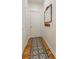 Inviting entryway featuring wood floors and an ornate patterned rug, leading to a pristine white door at 5010 Winding Hills Ln, Woodstock, GA 30189