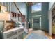 Bright foyer features a staircase, high ceilings, and an open doorway to the outside at 5010 Winding Hills Ln, Woodstock, GA 30189
