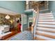 Foyer with staircase, hardwood floors, and an open view into the adjacent living spaces at 5010 Winding Hills Ln, Woodstock, GA 30189