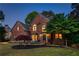 Charming brick home featuring a landscaped front yard and inviting front door at 5010 Winding Hills Ln, Woodstock, GA 30189