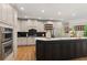 Gourmet kitchen featuring stainless appliances, custom cabinets, and modern fixtures at 5010 Winding Hills Ln, Woodstock, GA 30189
