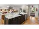 Gourmet kitchen with a large center island, marble countertops, stainless appliances, and hardwood floors at 5010 Winding Hills Ln, Woodstock, GA 30189