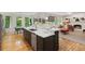 Open-concept kitchen with a large center island, modern appliances, and an open view into the living room at 5010 Winding Hills Ln, Woodstock, GA 30189