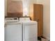 Modern laundry room with front-load washer and dryer, complemented by stylish black and white tiled floor at 5010 Winding Hills Ln, Woodstock, GA 30189