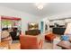 Open concept living room with hardwood floors, a fireplace, and views into the modern kitchen at 5010 Winding Hills Ln, Woodstock, GA 30189
