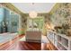 Stylish living room boasts hardwood floors, colorful wallpaper, and natural light at 5010 Winding Hills Ln, Woodstock, GA 30189