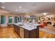 Spacious living room and kitchen area featuring an island and plenty of natural light at 5010 Winding Hills Ln, Woodstock, GA 30189