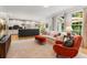 Spacious living room with hardwood floors, a fireplace, and an open view into the modern kitchen at 5010 Winding Hills Ln, Woodstock, GA 30189