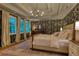 Spacious main bedroom featuring stylish wallpaper, tray ceiling, and bright windows with natural light at 5010 Winding Hills Ln, Woodstock, GA 30189