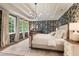 Stunning main bedroom with wallpaper, a tray ceiling, and well-lit with three large windows at 5010 Winding Hills Ln, Woodstock, GA 30189
