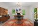 Bright home office space with hardwood desk, modern lighting, and a large colorful decorative rug at 5010 Winding Hills Ln, Woodstock, GA 30189