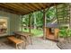 A covered patio area underneath a raised deck with a picnic table and a playhouse overlooking the yard at 5010 Winding Hills Ln, Woodstock, GA 30189