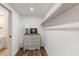 A walk-in closet area in a finished basement with shelving and wood floors at 5010 Winding Hills Ln, Woodstock, GA 30189