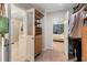 Walk-in closet with custom storage leads to a hallway, with views to a bedroom with stylish wallpaper at 5010 Winding Hills Ln, Woodstock, GA 30189