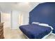 Bedroom with a blue accent wall and a large window; view to the en-suite bath at 5174 Ridge Tarn, Acworth, GA 30102
