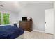 Bedroom with a large window and view to the trees; dresser with TV at 5174 Ridge Tarn, Acworth, GA 30102