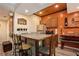 Rustic kitchenette featuring corrugated metal, a built-in bar, and a cozy bench for casual dining at 5174 Ridge Tarn, Acworth, GA 30102